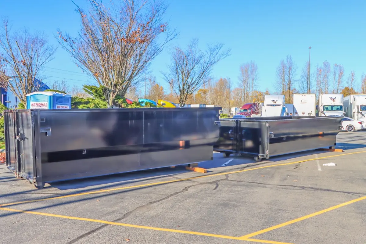 Professional dumpster rental service with roll-off container on residential driveway in Lower Allen